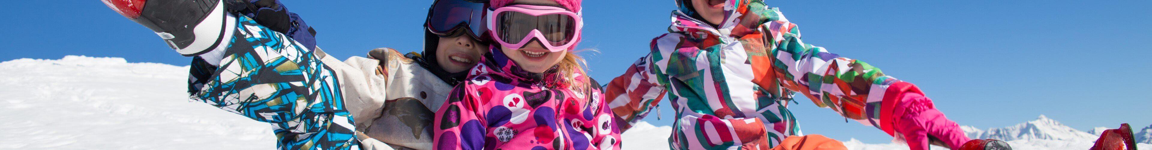Family skiing together on a sunny piste