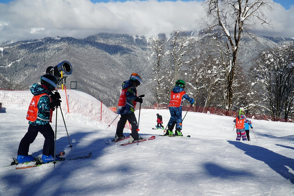 Family skiing together on a sunny piste